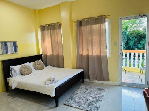 a bedroom with a bed and a sliding glass door at Paradise panglao pool villa 
