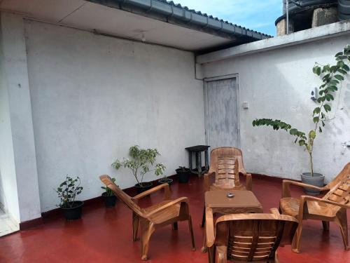 a patio with chairs and a table and a stove at Lovely FLowers in Mount Lavinia in Mount Lavinia
