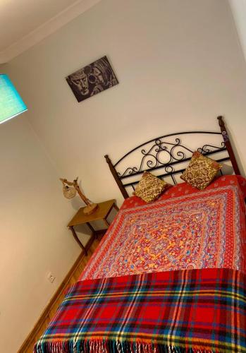 - une chambre avec un lit et une couette colorée dans l'établissement Merkezde elçiliklere yakın konforlu özel oda, à Ankara