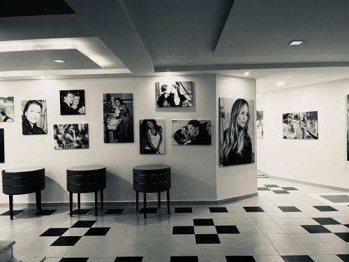 a room with pictures on the wall and two chairs at Beachfront Marilyn in Durrës