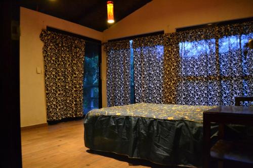 a bedroom with a bed and a window at CABAÑA EL SALTO 2 in Tzicuilán