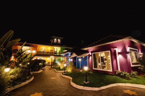 a house at night with lights in the yard at Cherryleen Resort Nagaon Alibaug in Nagaon