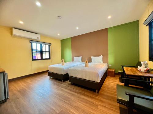 Postel nebo postele na pokoji v ubytování Napdown Resort Trat นับดาว รีสอร์ท ตราด