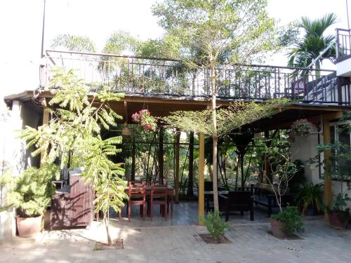 a patio with a table and a balcony with plants at The Chill River-Boutique Villa in Siem Reap