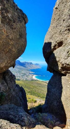 a view of the ocean from between two large rocks at Dolliwarie Guesthouse in Panorama