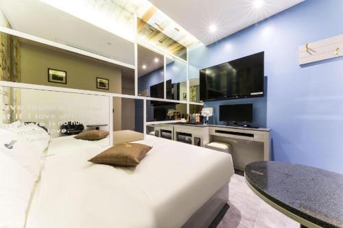 a bedroom with a large white bed and a table at Y Hotel in Seoul