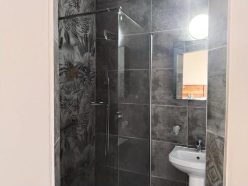 a bathroom with a shower and a sink at 5 Telena in Umdloti