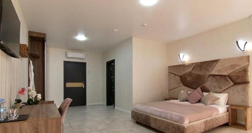 a bedroom with a large bed and a desk in it at Four Seasons In Carpathians in Migovo