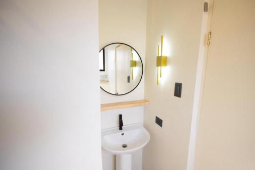 a bathroom with a white sink and a mirror at Happiness Hostel Boracay in Boracay