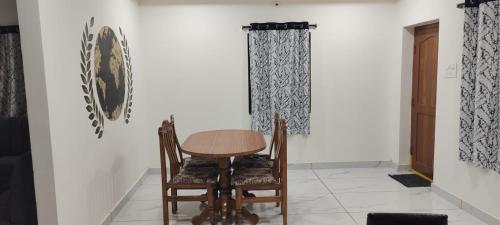 a dining room with a table and two chairs at 4 KING SIZE BEDROOM DUPLEX VILLA in Hyderabad