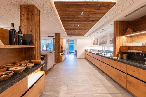 a bakery with wooden counters and a long aisle at Hotel Edelweiss Superior in Kaunertal