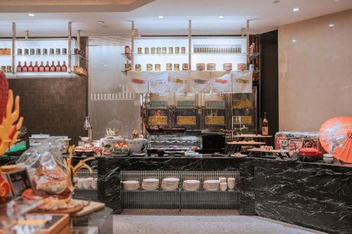 a restaurant with a counter with food on it at Shangri-La Wuhan,Close to The Mixc with three subway lines in Wuhan