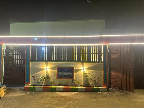 a building with plants in front of it with lights at VM Residency in Yelagiri