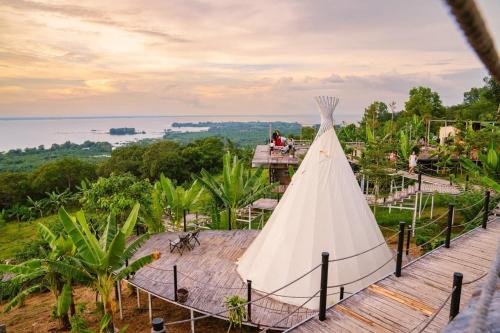 a wedding dress on top of a building with a view at Panorama Glamping in Tân Phú