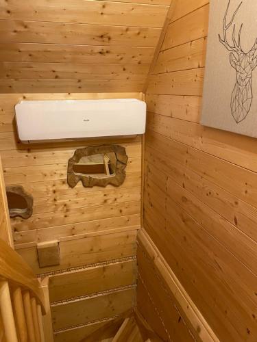 a log cabin bathroom with a sink and a stove at Wioska Jasia i Małgosi in Izdebnik