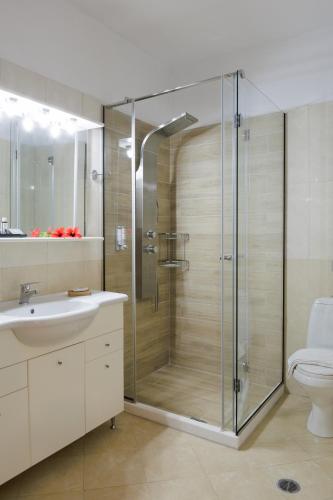 a bathroom with a shower and a sink and a toilet at Blue Horizon Suites in Paralion astros