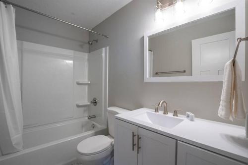 y baño con lavabo, aseo y espejo. en Comfortable Modern Home w/ Game Room, en American Fork