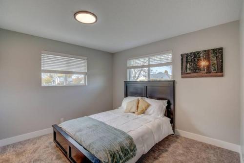 1 dormitorio con 1 cama y 2 ventanas en Comfortable Modern Home w/ Game Room, en American Fork