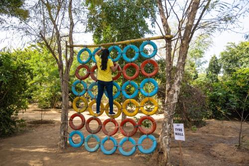 a woman standing on top of a wall of hoops at Aranya by Stories in Jaipur