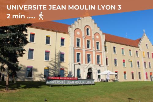 a large building with a sign in front of it at Le Tournassin-Balcon-Stationnement gratuit in Bourg-en-Bresse