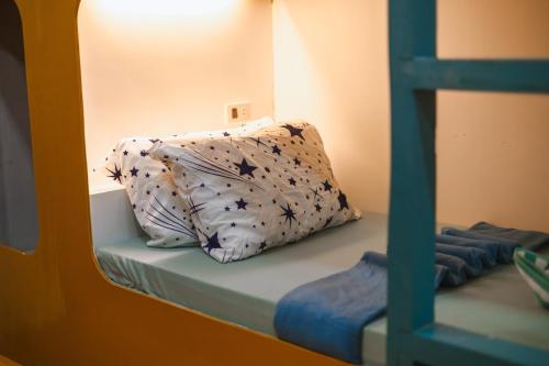 a pillow sitting on top of a bunk bed at El Nido Home Stay in El Nido