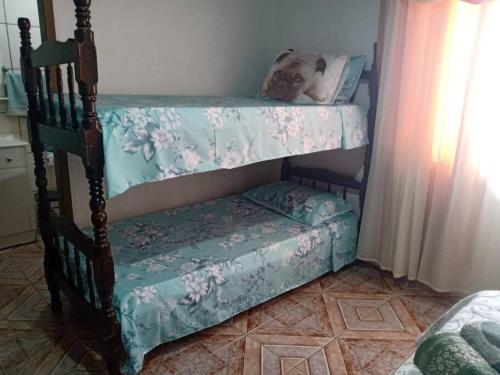 a bedroom with a bunk bed with a bench at Casa linda e aconchegante para hóspedes.(Studio) in Joinville