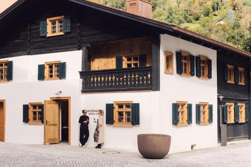 two people standing in the doorway of a building at Posthotel Taube in Schruns-Tschagguns
