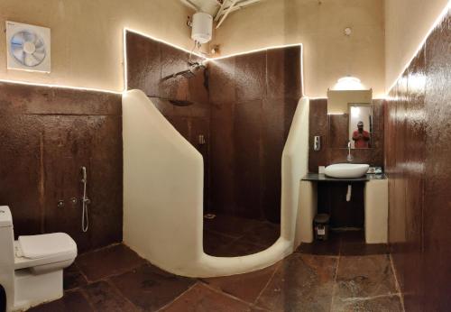 a bathroom with a shower and a toilet and a sink at Bastar Greens in Jagdalpur