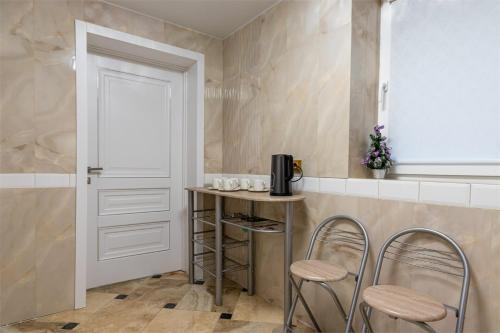 a kitchen with a small table and two stools at Zeleniy Bir in Bukovel