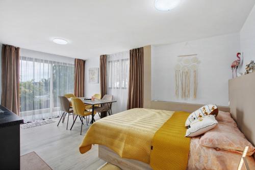 a bedroom with a bed and a table with chairs at Villa La Blanca in Arona