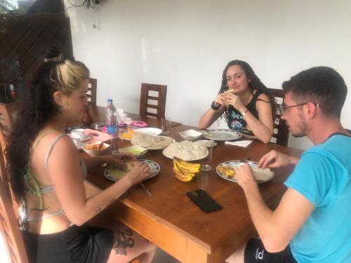 a group of people sitting around a table eating food at Senanayaka Holiday Inn in Polonnaruwa