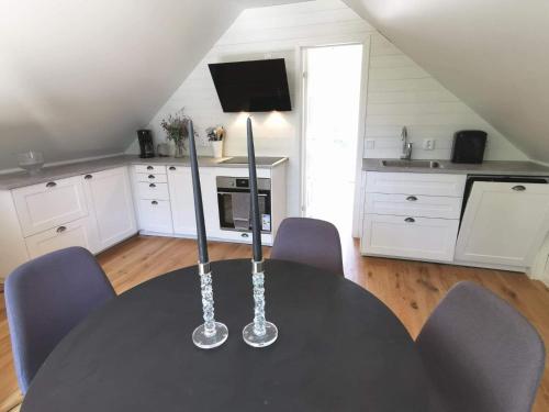 a table with two candlesticks on it in a kitchen at Årsta strand in Stockholm