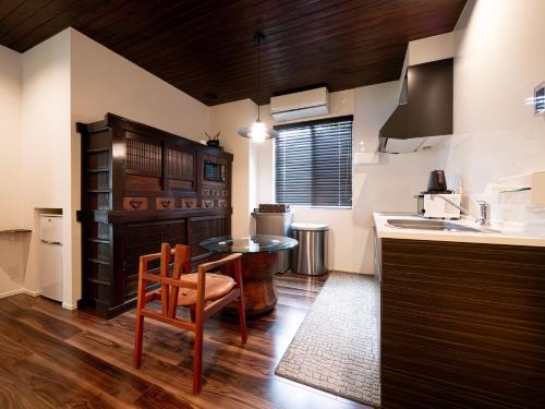 a kitchen with a table and a chair at SWEET VILLA TAKASAMA in Fujiyoshida