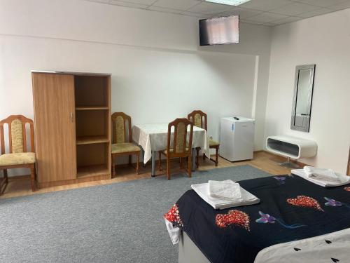 a hospital room with a bed and a table and chairs at Complex garsoniere. Studio Rentals in Onești