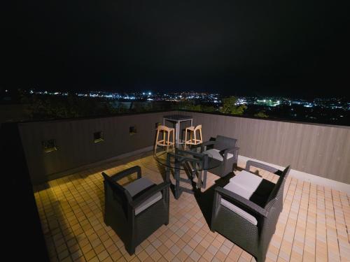 a balcony with chairs and a table on a roof at SWEET VILLA TAKASAMA in Fujiyoshida