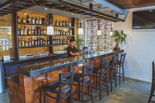 a man sitting at a bar in a restaurant at G Hotel in Dauis