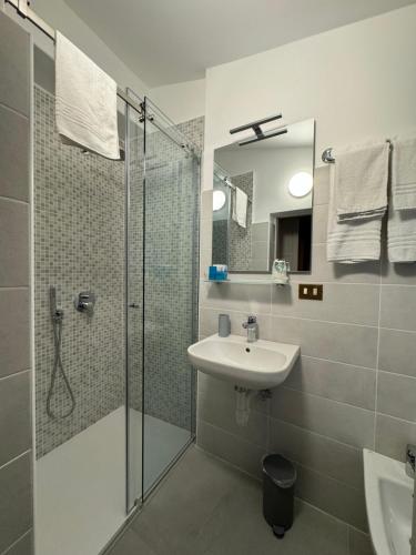 a bathroom with a glass shower and a sink at B&B Michelina in Castiglione dʼIntelvi
