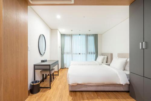a hotel room with a bed and a desk at Centum Convention Hotel In Centum in Busan