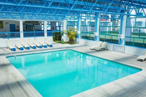 a large swimming pool in a building with chairs at 358 Kaliva - Club Mykonos in Langebaan