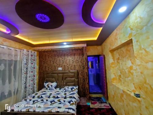 a room with a bed with purple lights on the ceiling at Chapri homestay in Srinagar