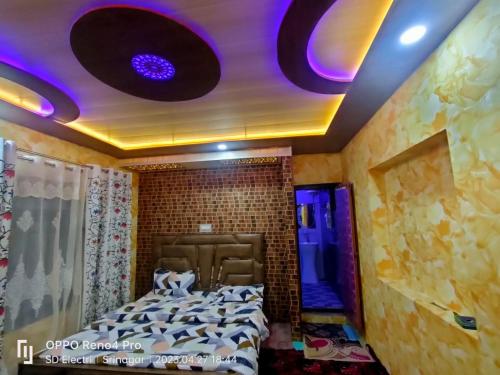 a bedroom with a bed with purple lights on the ceiling at Chapri homestay in Srinagar