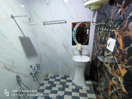 a bathroom with a toilet and a mirror at Chapri homestay in Srinagar