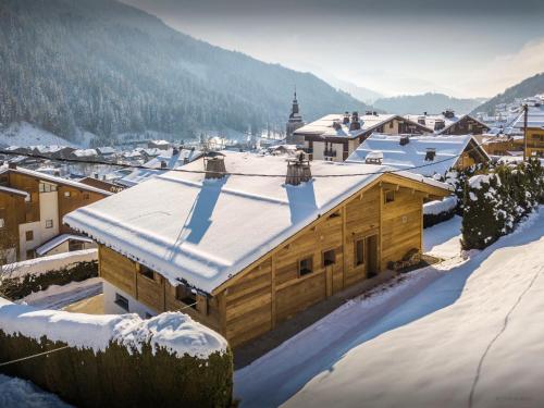 a wooden building with snow on top of it at Chalet Alyssum - OVO Network in Le Grand-Bornand