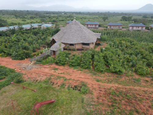 an aerial view of a farm with a building in a field at Tausa Tsavo Eco Lodge in Voi