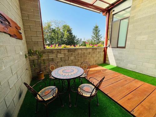 a patio with a table and chairs on a porch at City of Trees B&B in Sanxia