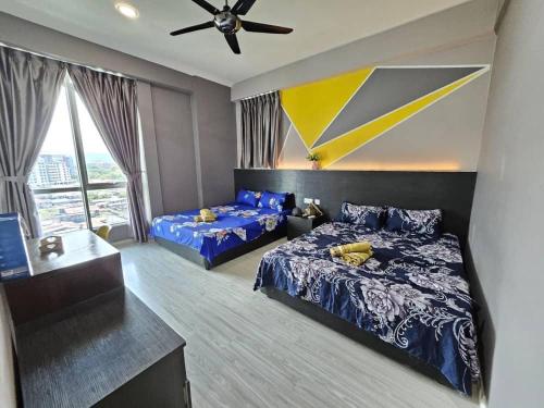 a bedroom with two beds and a ceiling fan at Cantara Escape Lily in Kota Kinabalu