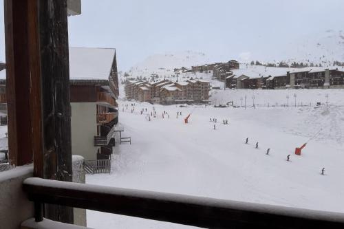 a group of people skiing on a snow covered slope at Snowflakes at La Plagne Soleil in La Plagne Tarentaise