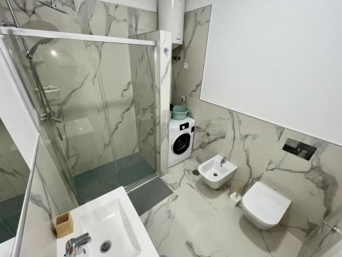 a bathroom with a toilet and a shower and a sink at 1 Island Village with Wi fi and Pool in Adeje