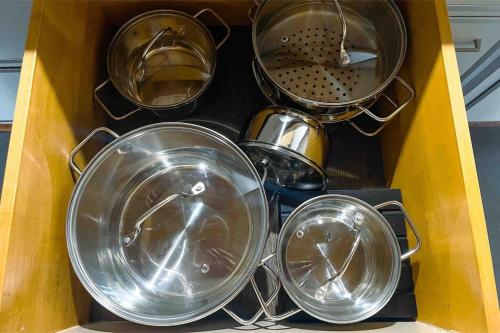 a box filled with pots and pans on a counter at -The Urbanist- Mountainview Parking Garden 3BD in Unterseen