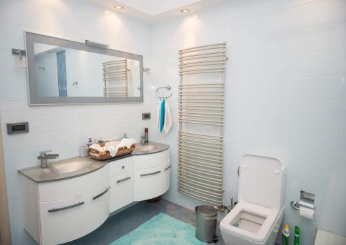 a white bathroom with a sink and a toilet at Villa Dalousa Retreat - Porto Heli in Porto Heli
